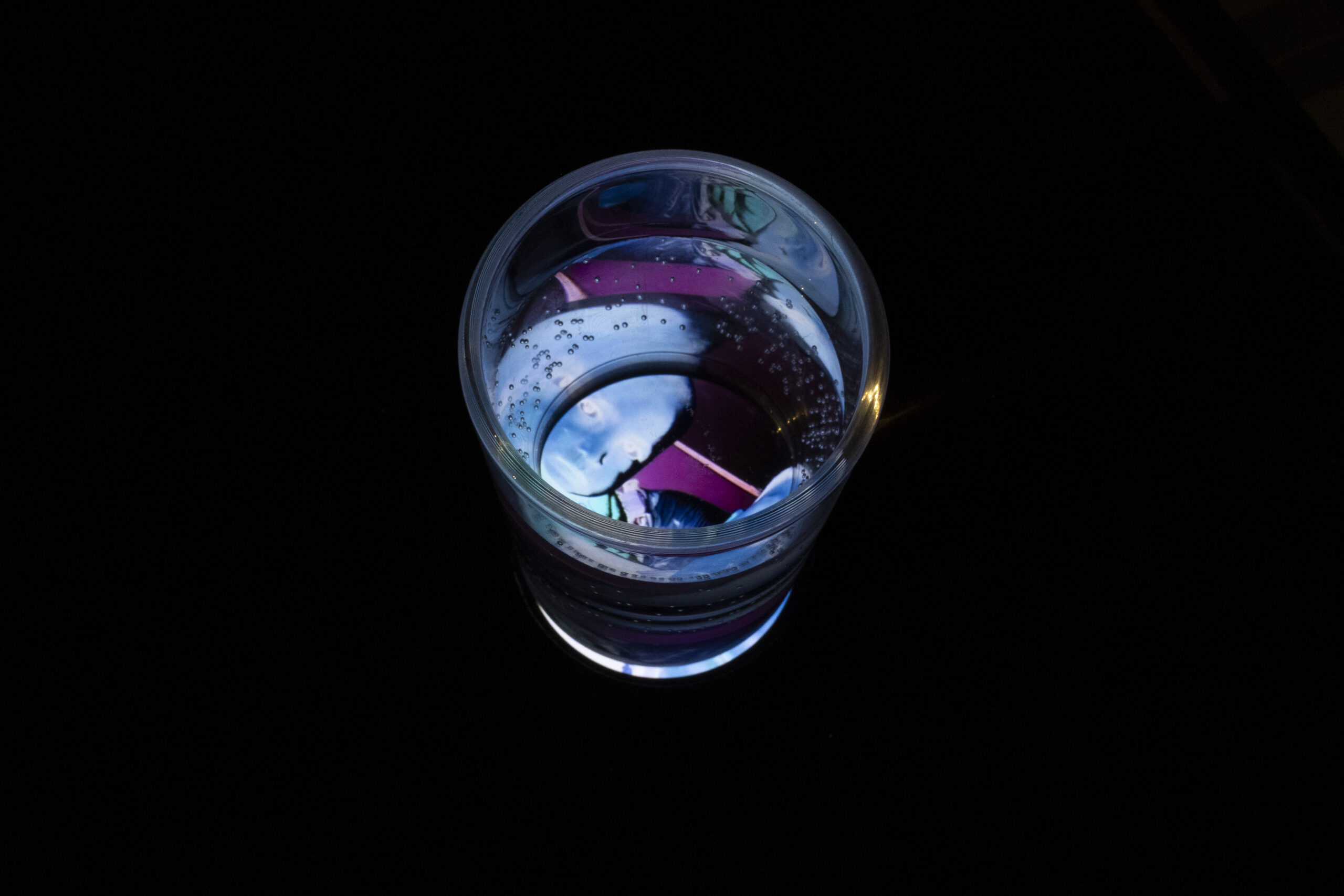 The weight of your gaze in a glass of water